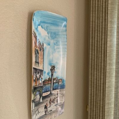 Sale Photo Thumbnail #32: Hand-painted Italian ceramic wall plaque depicting a Venetian cityscape, featuring a glossy glazed finish and signature at the bottom.
