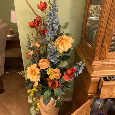 Sale Photo Thumbnail #48: Tall faux floral arrangement featuring peach dahlias, blue delphiniums, and red blossoms in a textured beige floor vase.
