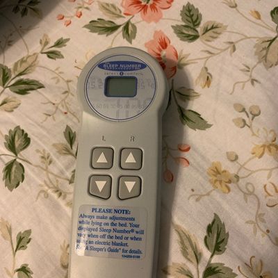 Sale Photo Thumbnail #107: Select Comfort Sleep Number bed remote controller resting on a floral mattress cover.