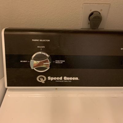 Sale Photo Thumbnail #85: Control panel of a Speed Queen commercial heavy-duty dryer featuring a fabric selector knob.