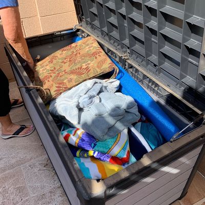 Sale Photo Thumbnail #29: Large outdoor resin deck box filled with pool noodles, towels, and patio chair cushions.