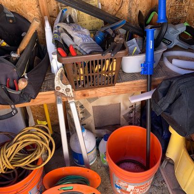 Sale Photo Thumbnail #21: Collection of assorted garden and workshop tools, including loppers, extension cords on reels, tool bags, and a 5-gallon Home Depot bucket.