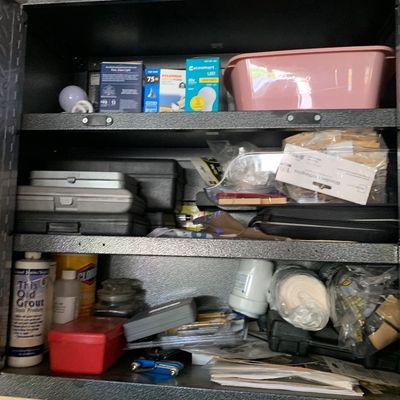 Sale Photo Thumbnail #120: Gladiator metal wall cabinet filled with household supplies, light bulbs, tool cases, and cleaning products.