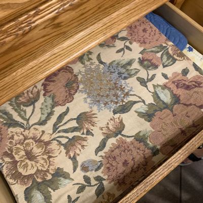 Sale Photo Thumbnail #59: Open wooden furniture drawer filled with a floral tapestry fabric pad or cushion.