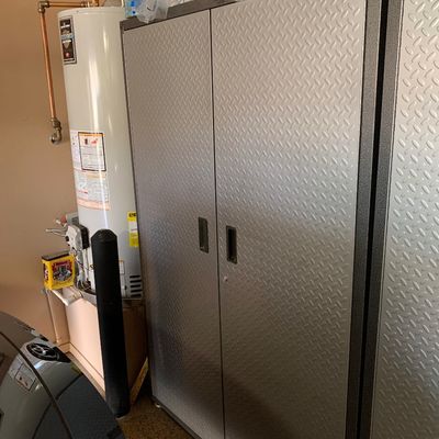 Sale Photo Thumbnail #119: Gladiator diamond plate double-door metal garage storage cabinet shown in a garage setting alongside household paper products.