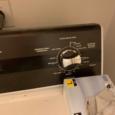 Sale Photo Thumbnail #86: Control panel of a top-loading clothes dryer featuring a cycle selection dial.