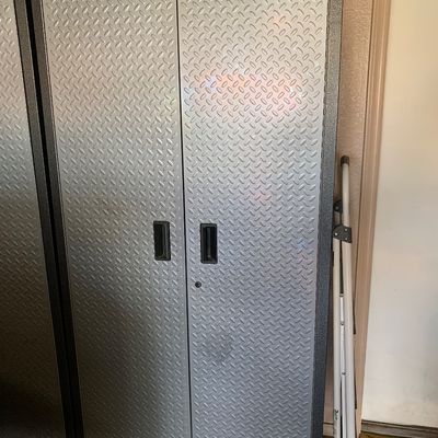 Sale Photo Thumbnail #117: Gladiator metal garage storage cabinet featuring diamond plate texture doors and a key lock.