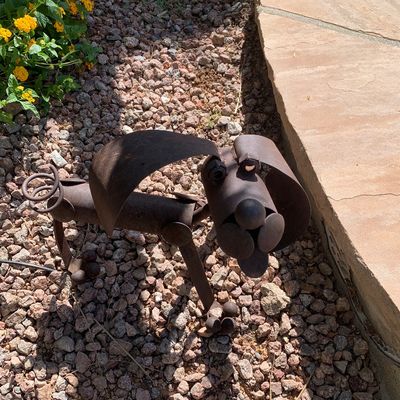 Sale Photo Thumbnail #11: Whimsical rustic scrap metal dog sculpture with floppy ears and a curly tail, designed for garden or patio decor.