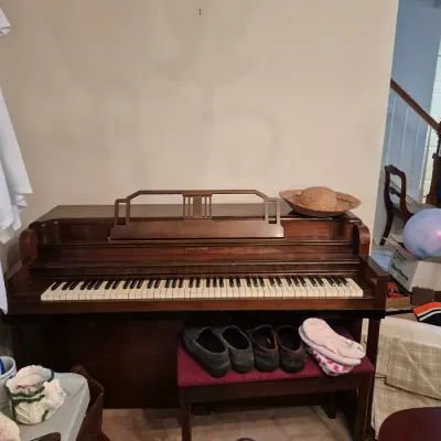 Sale Photo Thumbnail #4: Vintage Story & Clark dark wood upright piano with a matching maroon upholstered bench.
