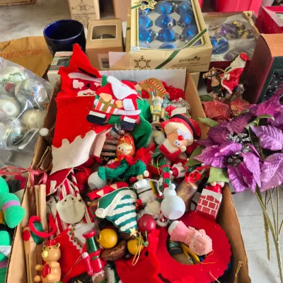 Sale Photo Thumbnail #40: Large collection of vintage Christmas decorations, including handmade felt ornaments, wooden figures, boxed glass baubles, and faux purple poinsettias.