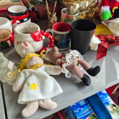 Sale Photo Thumbnail #36: Collection of holiday items, including vintage Santa Claus novelty mugs, plush reindeer and angel figurines, and boxed gold Christmas ornaments.