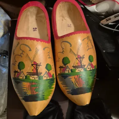 Sale Photo Thumbnail #56: Pair of vintage hand-painted Dutch wooden clogs featuring a windmill scene with red trim, marked size 24.