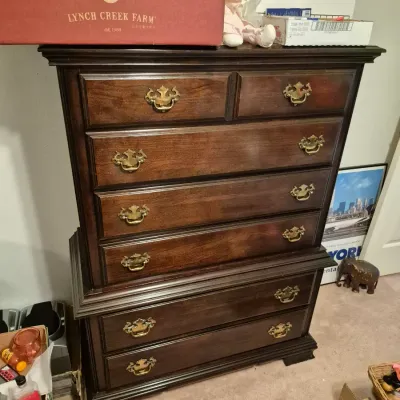 Sale Photo Thumbnail #44: Traditional dark wood chest-on-chest dresser with brass bail handles and molded trim details.