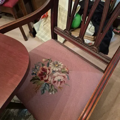 Sale Photo Thumbnail #8: Vintage dark wood armchair featuring a pierced banister back and a dusty rose needlepoint seat cushion embroidered with a floral bouquet.
