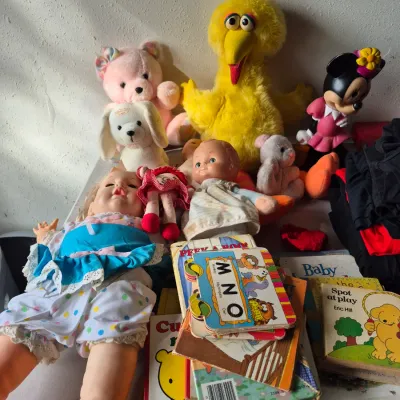 Sale Photo Thumbnail #33: Collection of vintage children's plush toys, dolls, and board books, including a Big Bird plush, Minnie Mouse figure, and Eric Hill's "Spot at Play".