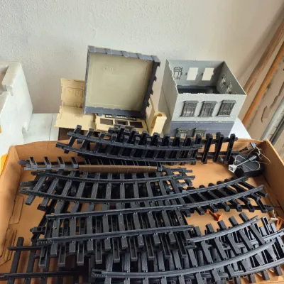 Sale Photo Thumbnail #23: Collection of model train tracks and K-Line plastic building accessories in a cardboard box.
