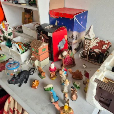 Sale Photo Thumbnail #24: Collection of holiday decor featuring miniature Nativity figurines, Christmas village houses with original boxes, and Halloween plastic rat figures.