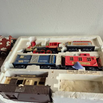Sale Photo Thumbnail #22: Vintage Silver Rail Express toy train set in its original styrofoam packaging, including locomotive, cars, and a Western Station structure.