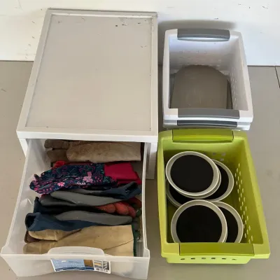 
(4) Small Plastic Organizers With Assorted Garden Gloves And Furniture Sliders