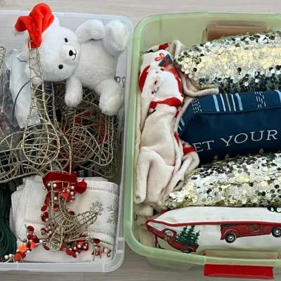 
(2) Plastic Totes With Christmas Decor - Pillows, Blanket, Towels, Mini Lights, Metal Reindeer
