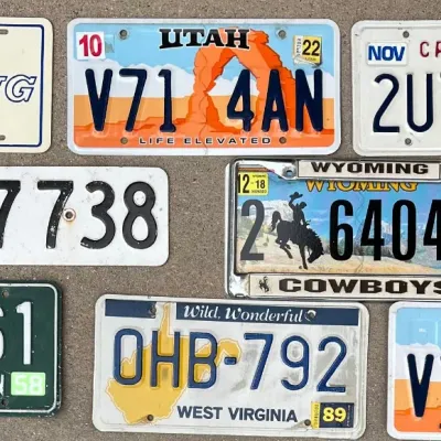 
(8) Assorted License Plates And Wall Hangings - Utah, Cali, Washington, Wyoming, Mustang