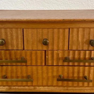
Mid Century Wooden Table Top Jewelry Chest With Fluted Drawer Fronts And Brass Hardware