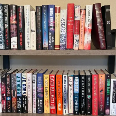 (2) Shelves Of Hard Back Books - Bard Thor, J. D. Robb, David Baldacci, Nora Roberts, And More