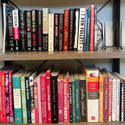 (2) Shelves Of Hard And Paper Back Books - Cook Books, Pioneer Woman, J.d. Robb, Stewart Woods, And More