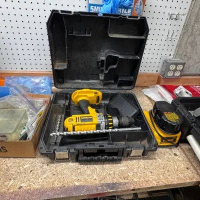 Sale Photo Thumbnail #55: Title: DeWalt XRP Cordless Drill Set | Category: Tools & Home Improvement | Power Tools. DeWalt XRP yellow and black cordless hammer drill, resting inside its original heavy-duty black molded plastic carrying case with metal latches, complete with drill b