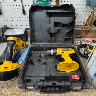 Sale Photo Thumbnail #56: DeWalt Cordless Power Tools and Hard Storage Case | Tools & Workshop Equipment. DeWalt cordless drill and heat gun set with a fitted black plastic hard carrying case, showing typical wear from workshop use.