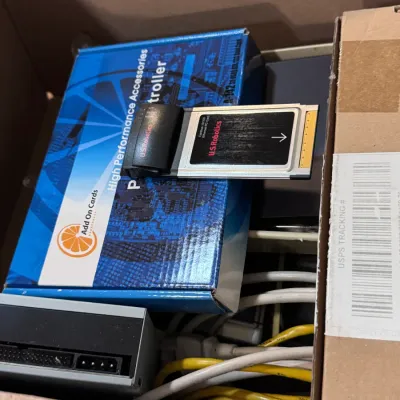 Sale Photo Thumbnail #39: Title: U.S. Robotics Megahertz Ethernet PC Card & Computer Parts | Category: Electronics > Vintage Computing. Vintage U.S. Robotics 10/100 Ethernet PC Card resting on an Add On Cards High Performance Accessories box, accompanied by assorted cables and har