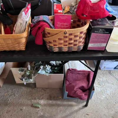 Sale Photo Thumbnail #10: Tabletop assortment featuring two woven wooden baskets, a black electronic carrying case, a boxed Blitz Sonic Jewelry Cleaner, a vintage red mesh trucker hat, and a copy of 'Fascinating Womanhood' by Helen B. Andelin.