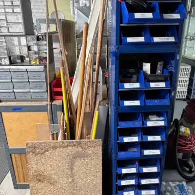 Sale Photo Thumbnail #45: Title: Blue Metal Storage Bin Rack Tower with Labeled Compartments. Category: Tools & Industrial Supplies. Tall blue metal industrial storage bin tower featuring multi-tiered blue plastic bins with labels, shown alongside small parts organizer cabinets an