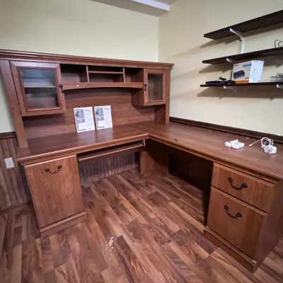 Sale Photo Thumbnail #31: Large Bush Furniture wooden L-shaped corner executive desk featuring an attached upper hutch with glass cabinet doors, cubbies, a pull-out keyboard tray, and built-in storage drawers.