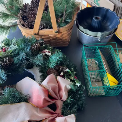 Sale Photo Thumbnail #14: Holiday Decor & Kitchenware Assortment. Categories: Home Decor > Seasonal & Holiday Decor; Home & Garden > Kitchen & Dining > Bakeware. Collection featuring a woven Longaberger-style wooden gathering basket filled with pine cones and faux greenery, a arti