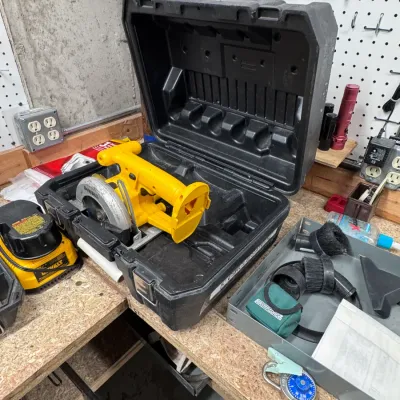 Sale Photo Thumbnail #54: Title: DeWalt 18V Cordless Circular Saw with Hard Case and Battery. Category: Power Tools / Saws / Cordless Tools. DeWalt 18-volt cordless 5 3/8-inch circular saw model DW936, made in USA, resting inside its original black molded plastic carrying case alo