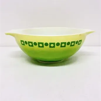 Sale Photo Thumbnail #40: Vintage Pyrex Cinderella casserole bowl in the Dot / Dot-3 pattern, featuring a lime green ombré exterior with dark green geometric shapes.