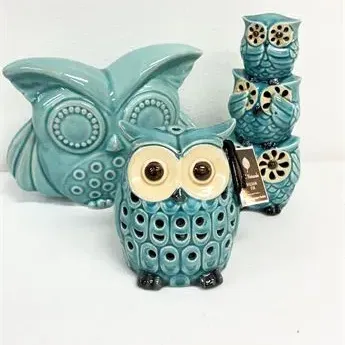 Sale Photo Thumbnail #6: Collection of teal ceramic owl decor pieces, including a teal votive holder, a stacked owl figurine, and a wide owl figurine.