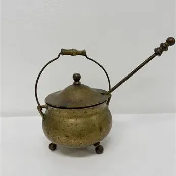 Sale Photo Thumbnail #58: Vintage brass holy water pot or incense burner with lid and long-handled spoon, featuring ball feet and an overhead swinging handle.