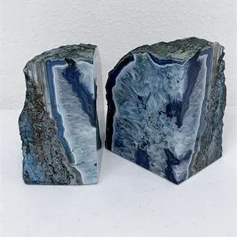 Sale Photo Thumbnail #46: Pair of polished blue agate geode bookends, featuring natural crystalline interiors and rough exterior edges.