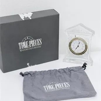 Sale Photo Thumbnail #67: Waterford Crystal 'Time Pieces' mantel clock featuring a classical pediment design, complete with its original presentation box and protective pouch.