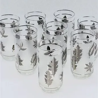 Sale Photo Thumbnail #28: Set of eight vintage mid-century frosted drinking glasses featuring silver metallic leaf patterns and silver rim bands.