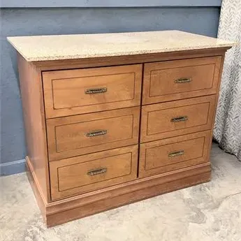 Sale Photo Thumbnail #9: Six-drawer wood dresser featuring a light granite top surface and decorative brass hardware.