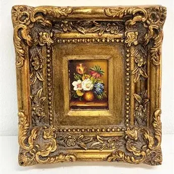 Sale Photo Thumbnail #32: Miniature oil painting of a floral still life housed in an ornate, heavily carved gold gilt frame.