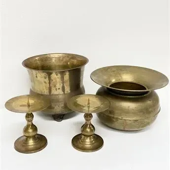 Sale Photo Thumbnail #44: Four-piece collection of aged brass decor, including a footed vessel, a wide-rimmed pot, and two matching pricket candlestick holders.