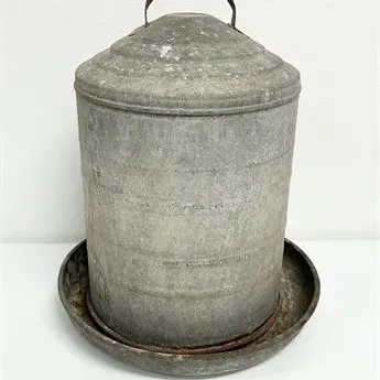 Sale Photo Thumbnail #64: Vintage galvanized metal poultry feeder with top handle and round base tray.
