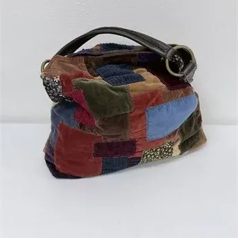 Sale Photo Thumbnail #47: Boho-style patchwork fabric shoulder bag featuring velvet, corduroy, and patterned swatches with dark brown leather handles.