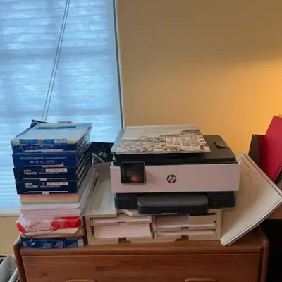 Sale Photo Thumbnail #16: HP all-in-one printer resting on desk organizers, accompanied by reams of printer paper and office supplies atop a wooden drawer unit.