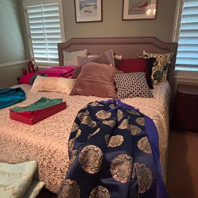 Sale Photo Thumbnail #53: Upholstered king-size bed with a taupe headboard, spread with decorative throw pillows, bedding, and a blue embroidered Asian silk garment.