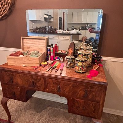 Sale Photo Thumbnail #125: Vintage burl wood vanity with mirror and cabriole legs, featuring an assortment of Asian decorative items, tea sets, and hand-painted canisters.